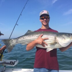 boy holding a striper fish